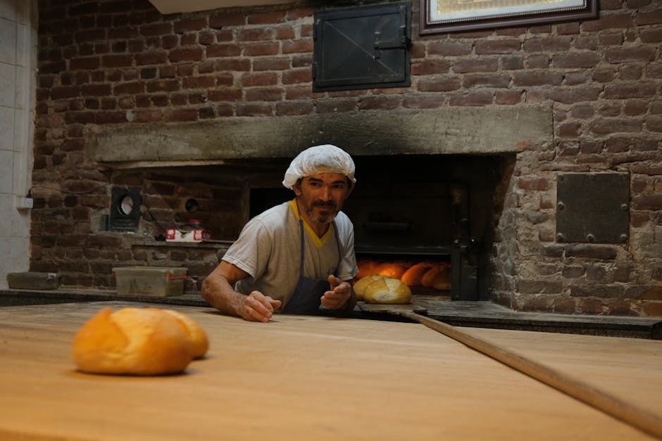 A skilled baker pulls fresh bread from a traditional brick oven, creating a warm, rustic atmosphere.